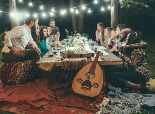 people sitting on chair in front of table with candles and candles