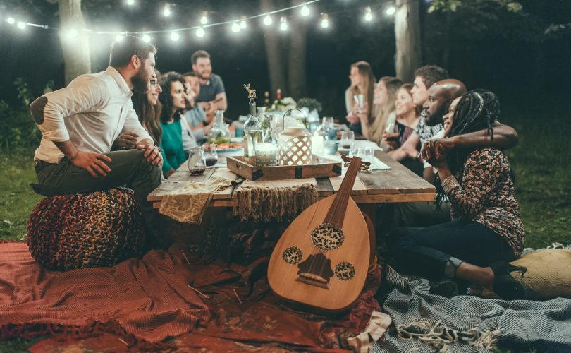 people sitting on chair in front of table with candles and candles